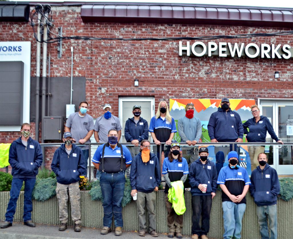 Photo of the Ground Works team with masks, standing in front of the HopeWorks Station South entrance.